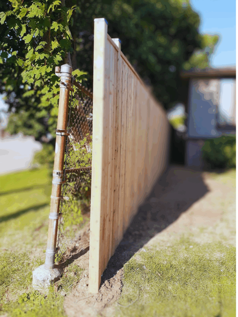 fence hiding chain link fence from neighboring school